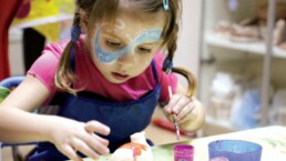 Grandchild creating personalised gift for grandma